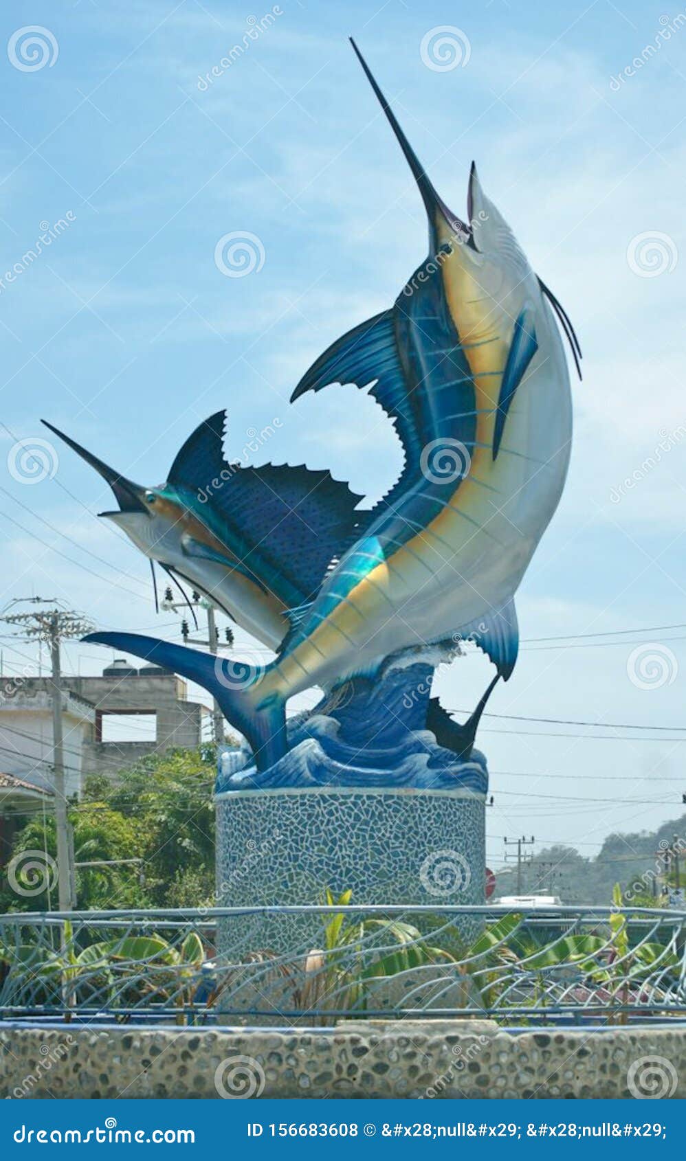 swordfish marlin fish pez vela sculpture on the street in a town by the beach outside a restaurant bar hotel