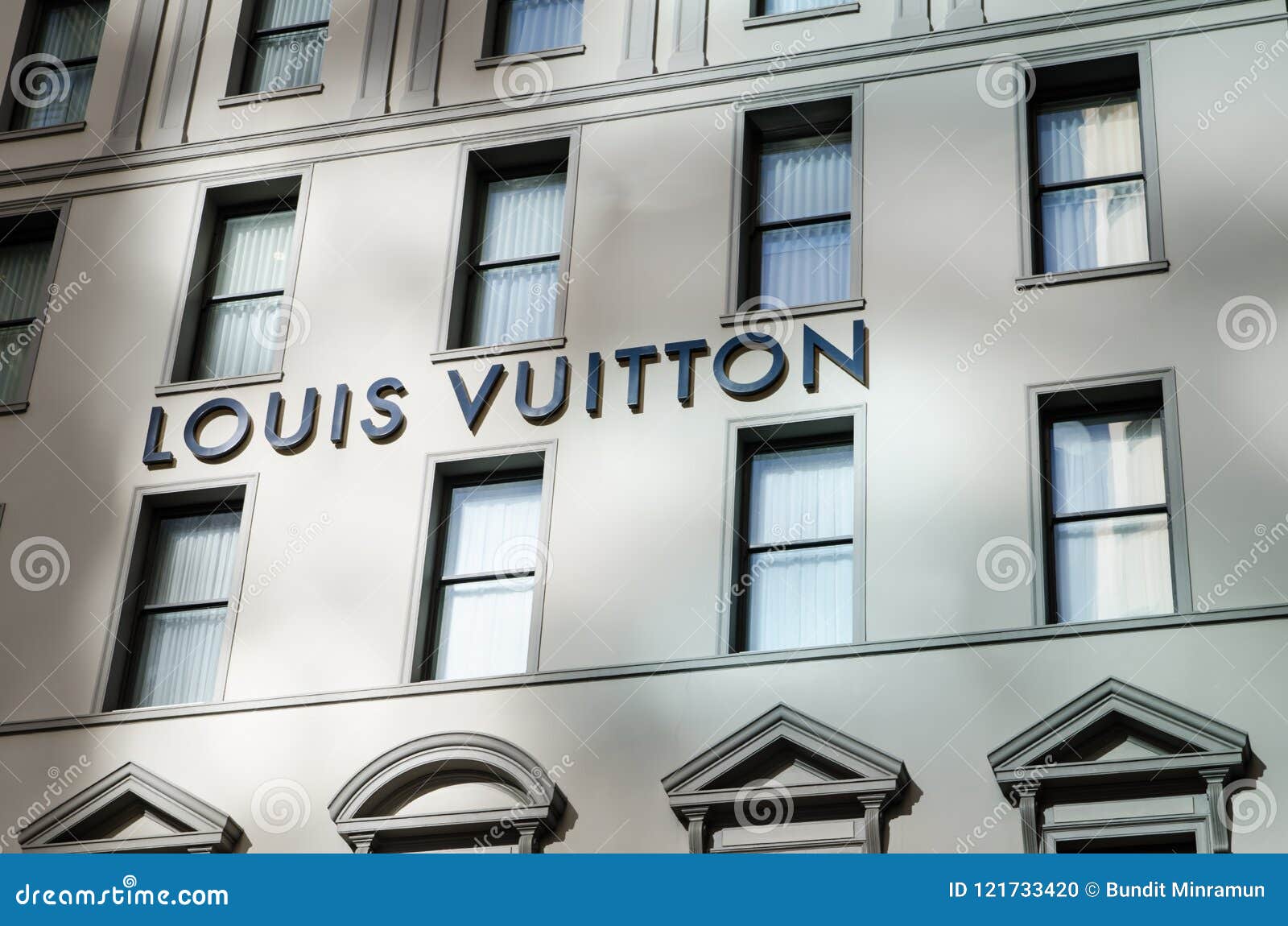 Louis Vuitton Symbol Text Logo on Grey Wall Building Store at