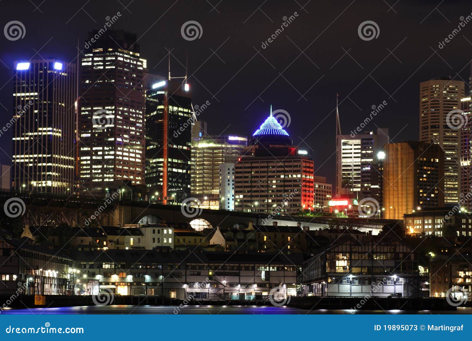 metropolitan city with wharf and skyline by night