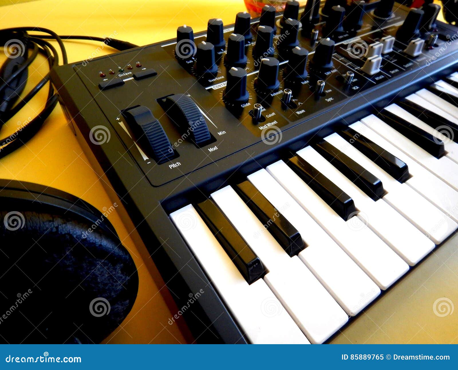 Synthesizer on Yellow Background with Orange Patch Cables and