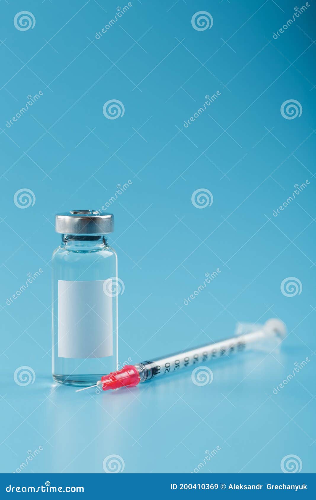 syringe and ampoule with a vaccine against viruses and diseases on a blue background