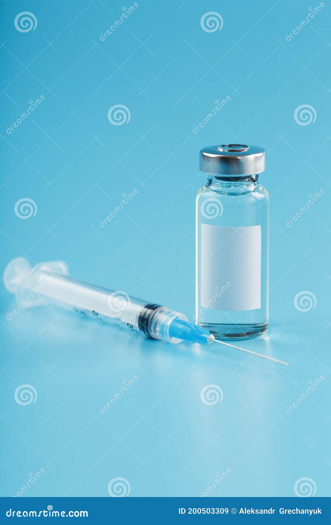 syringe and ampoule with a vaccine against viruses and diseases on a blue background