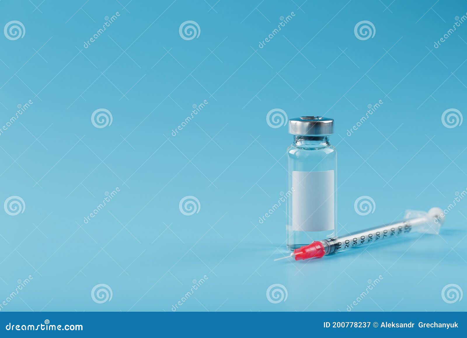 syringe and ampoule with a vaccine against viruses and diseases on a blue background