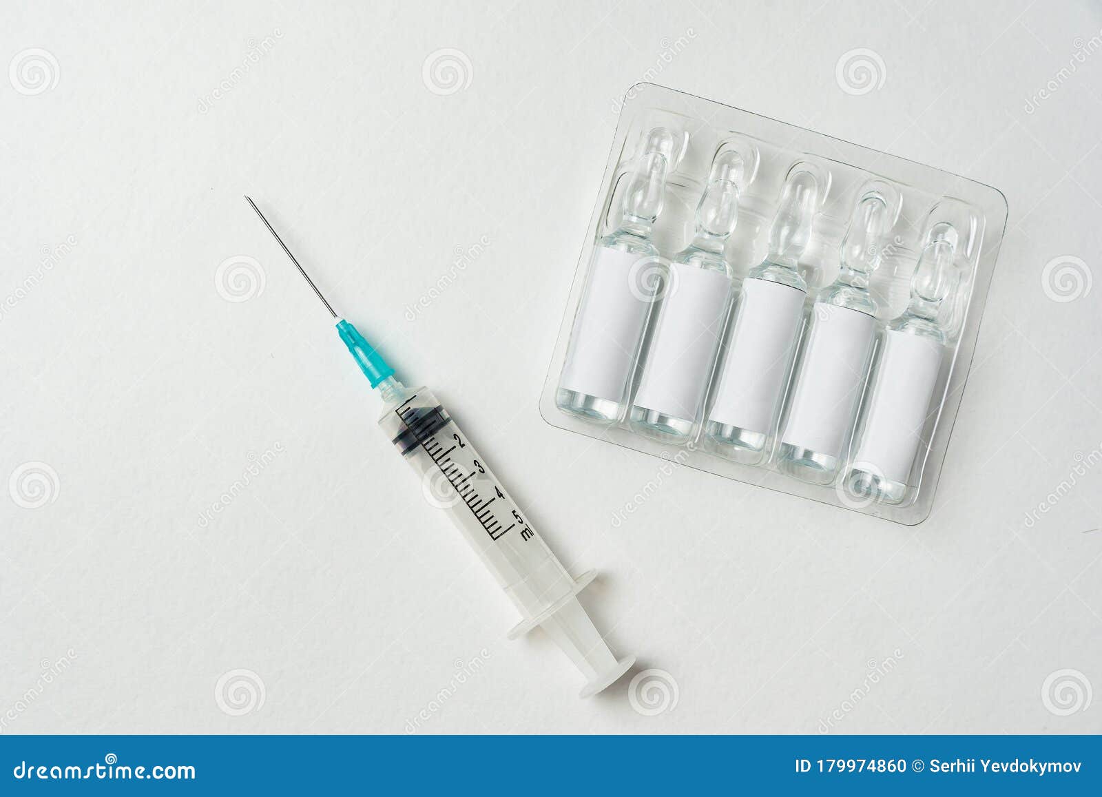 Syringe and Ampoules with Blank Label on White Background. Copy Space