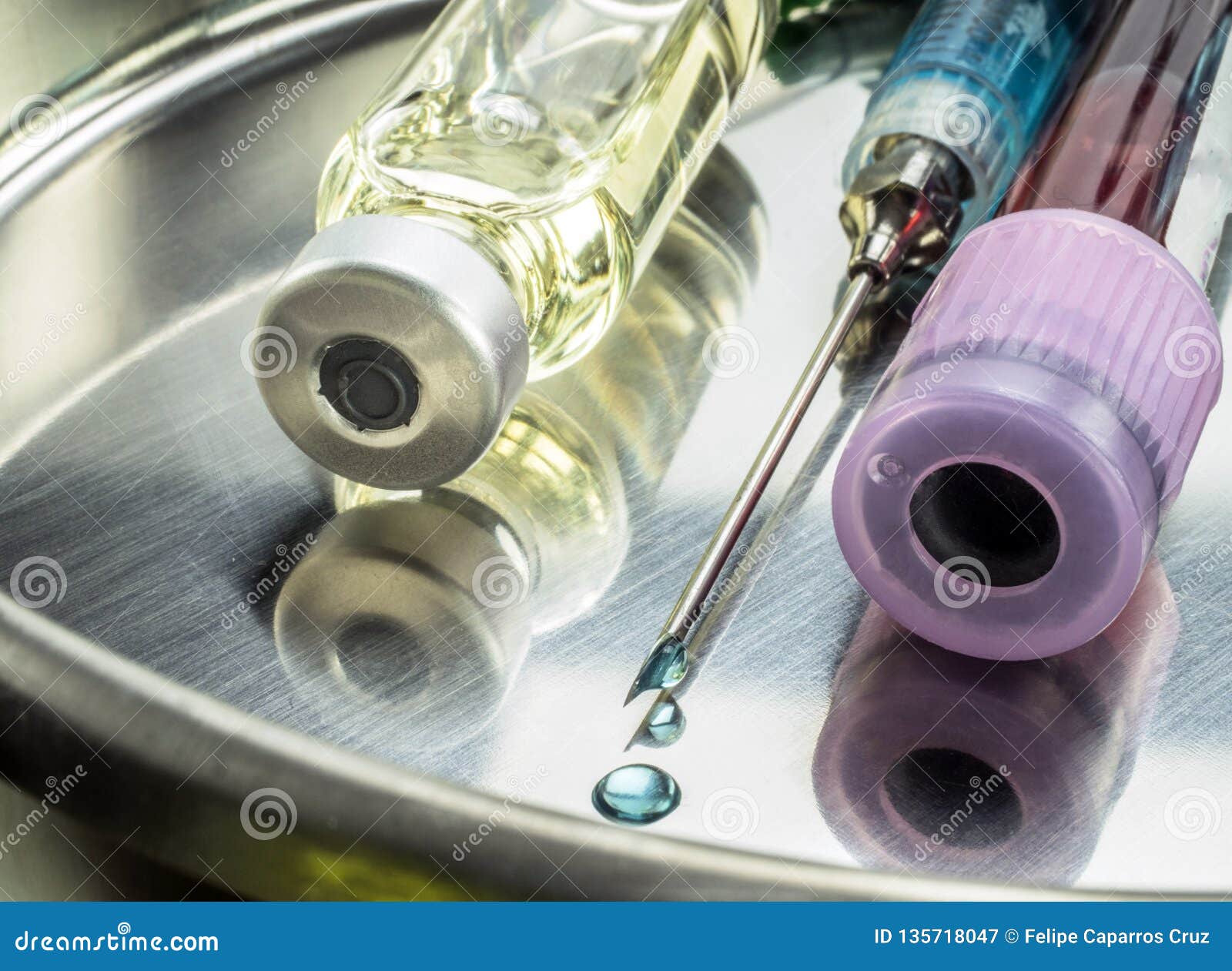 syringe with drop of medication in the needle