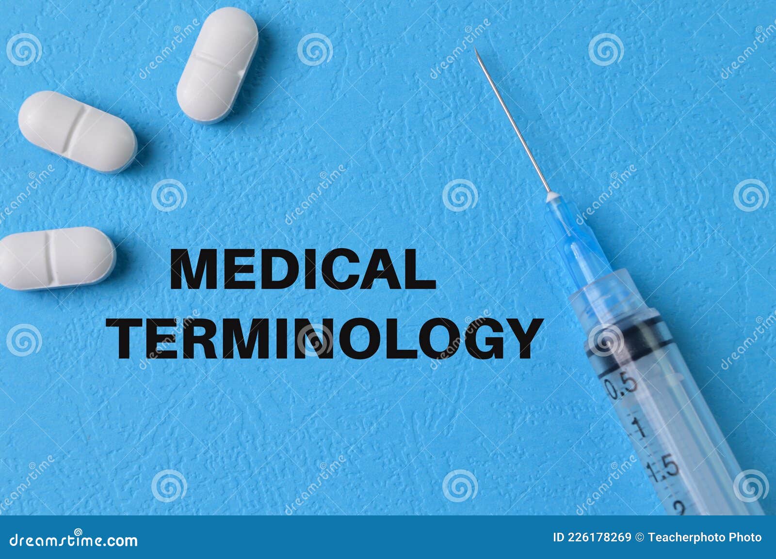 syringe injection and pill capsules on blue background with text medical terminology