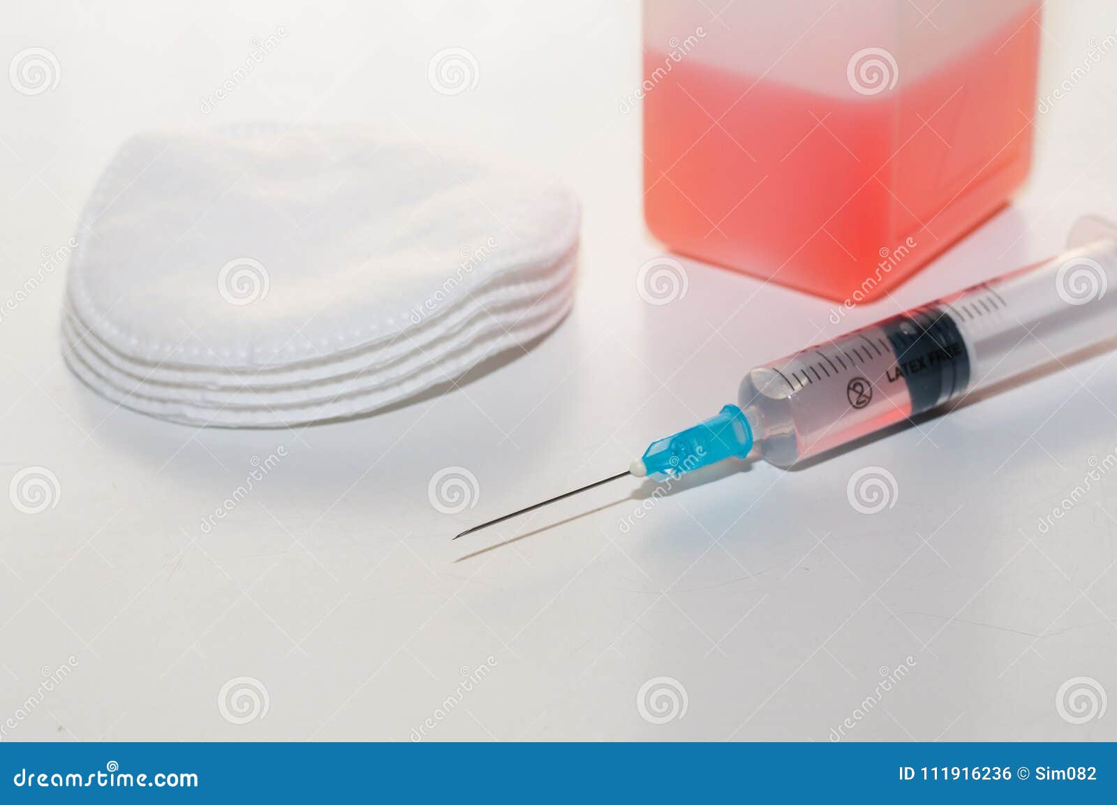 Syringe, Medical Alcohol Bottle and Cotton Wool. Stock Photo Image of