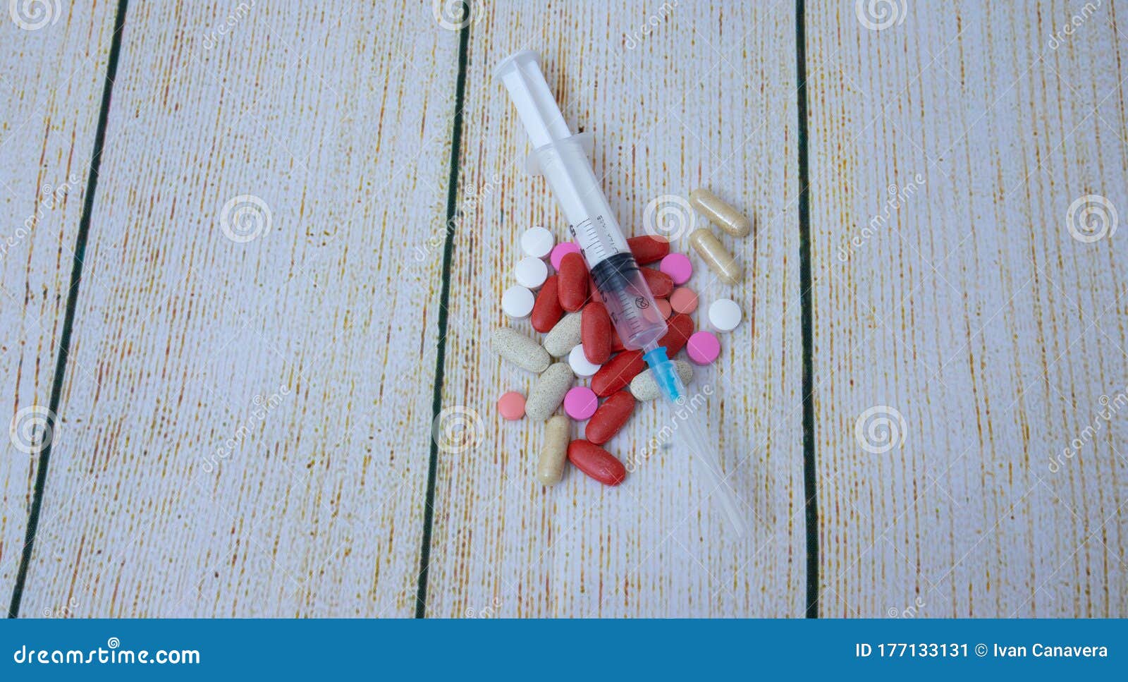 syringe and tablets of various color antivirus protection on white background