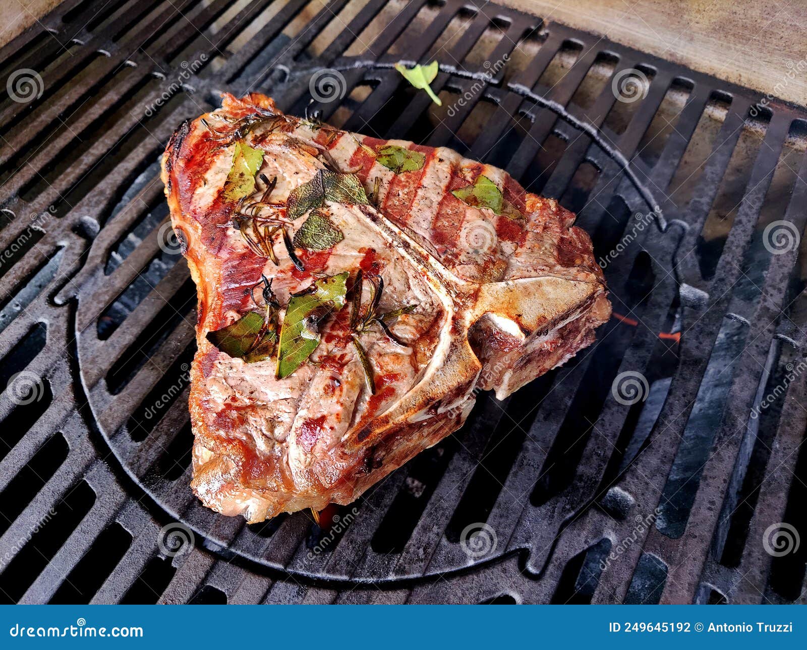 Tbone Steak Flavored with Herbs Cooks on the Grill Stock Photo Image