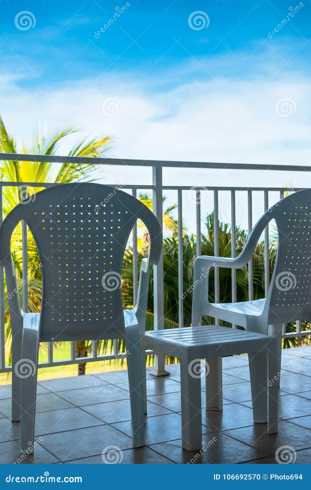 Table and Chairs on a Balcony, View of Blue Sky Stock Photo Image of