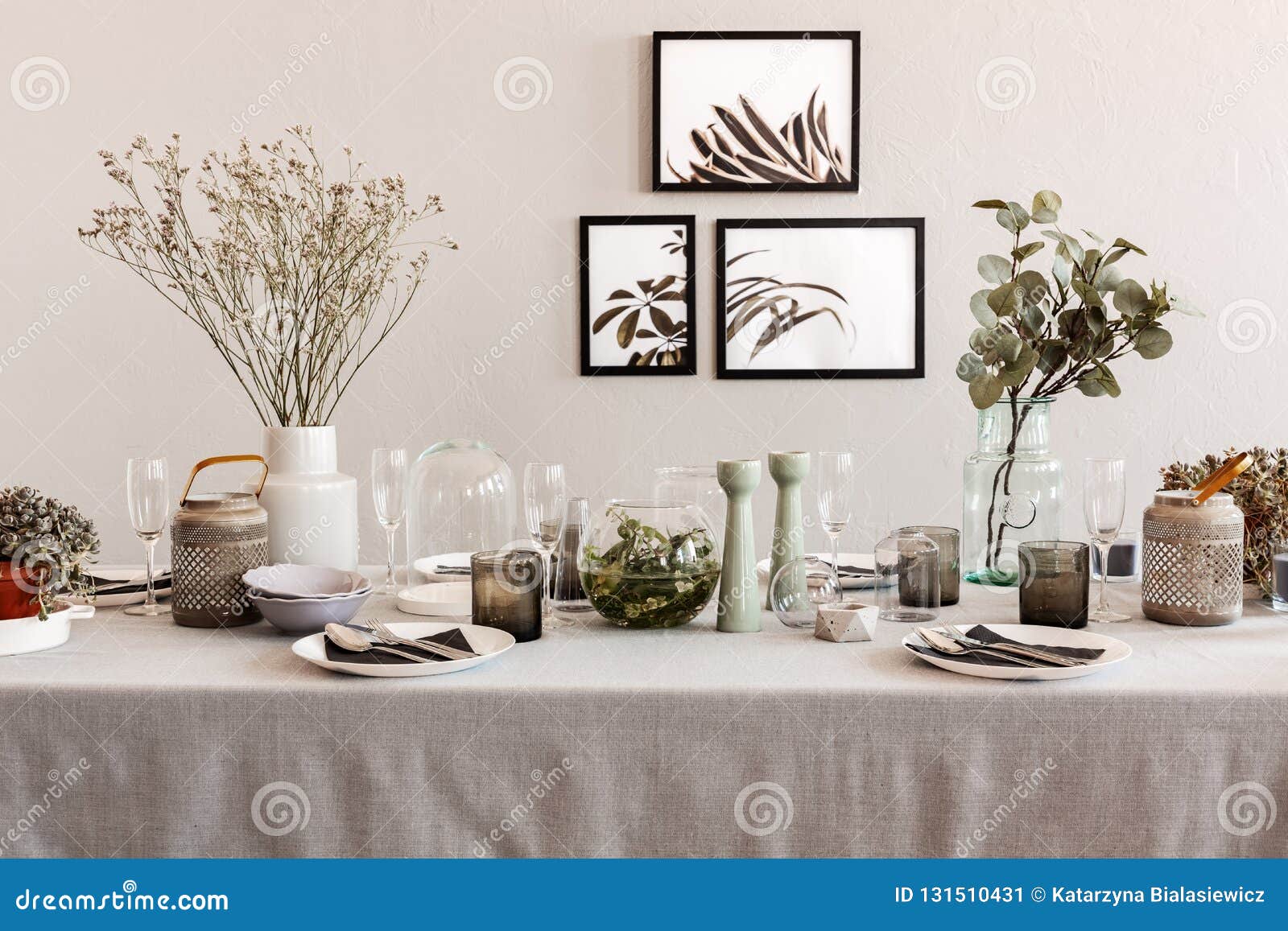 Table with Elegant Set for Dinner, Interior with Posters on the Wall