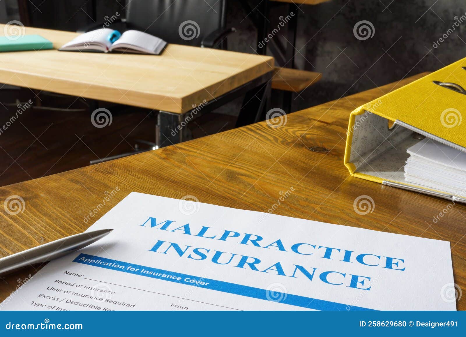 table with malpractice insurance application on it.