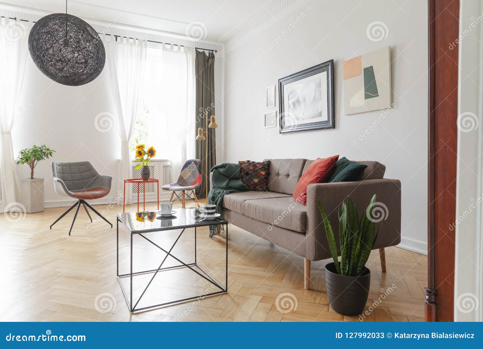 Table Next To Settee And Plant In Living Room Interior 