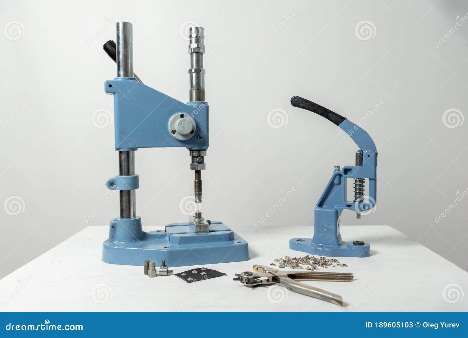 On the Table are Presses for Installing Buttons and Other Small Parts