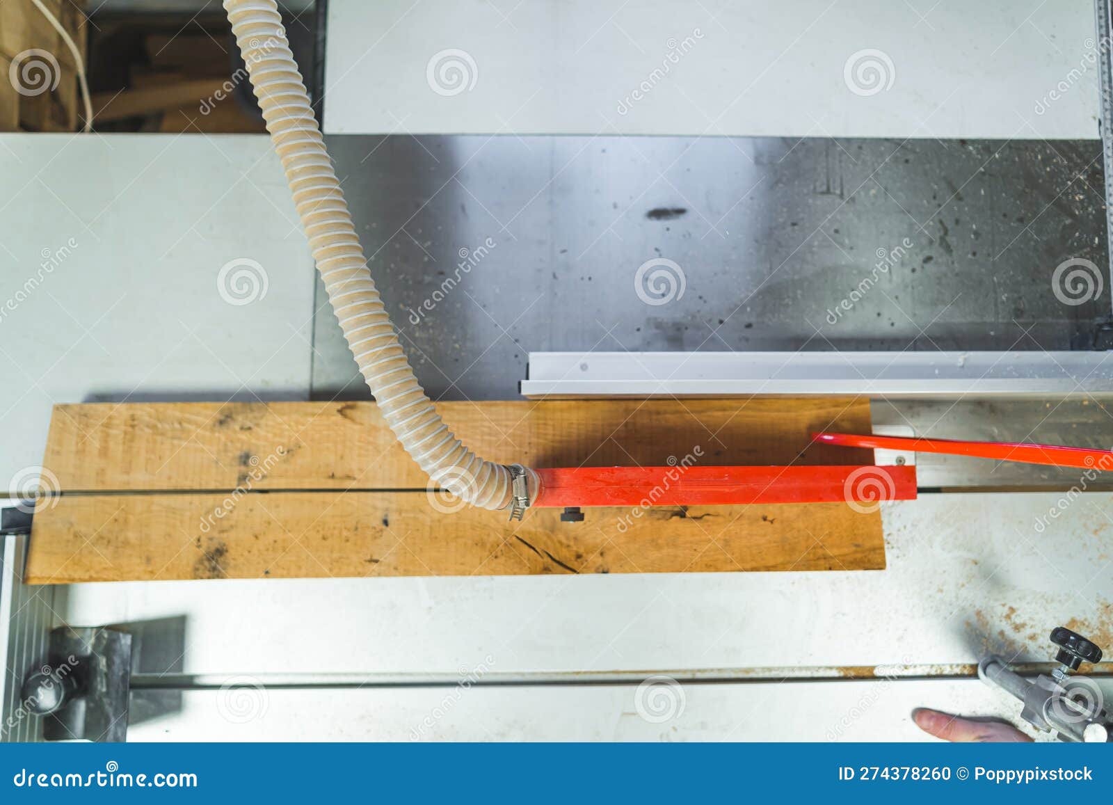 table saw blade and piece of wooden plank seen from high angle view. carpentering workshop essentials concept.