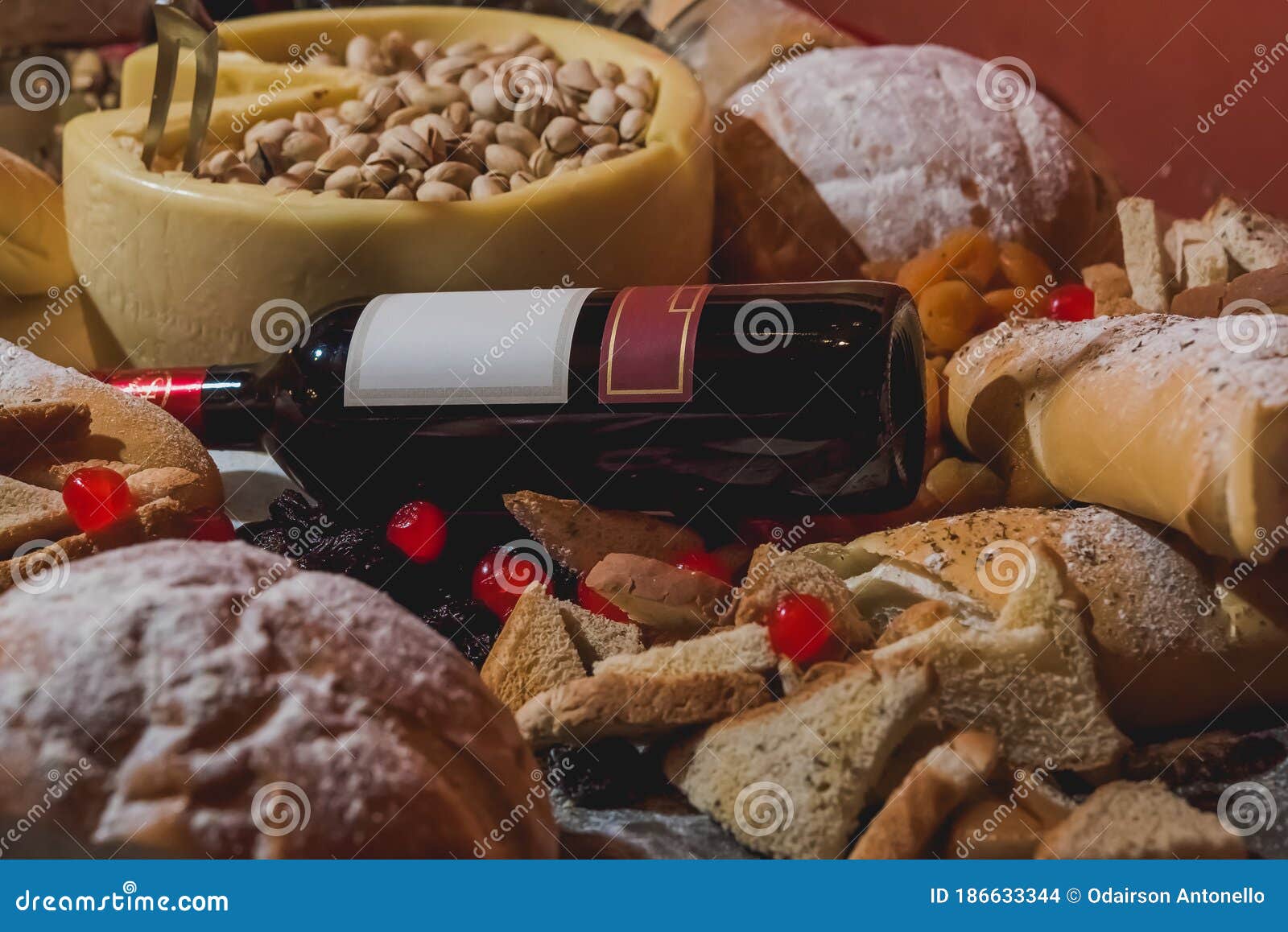 Table Set with Various Types of Breads, Cheese, Wine and Dried Fruits