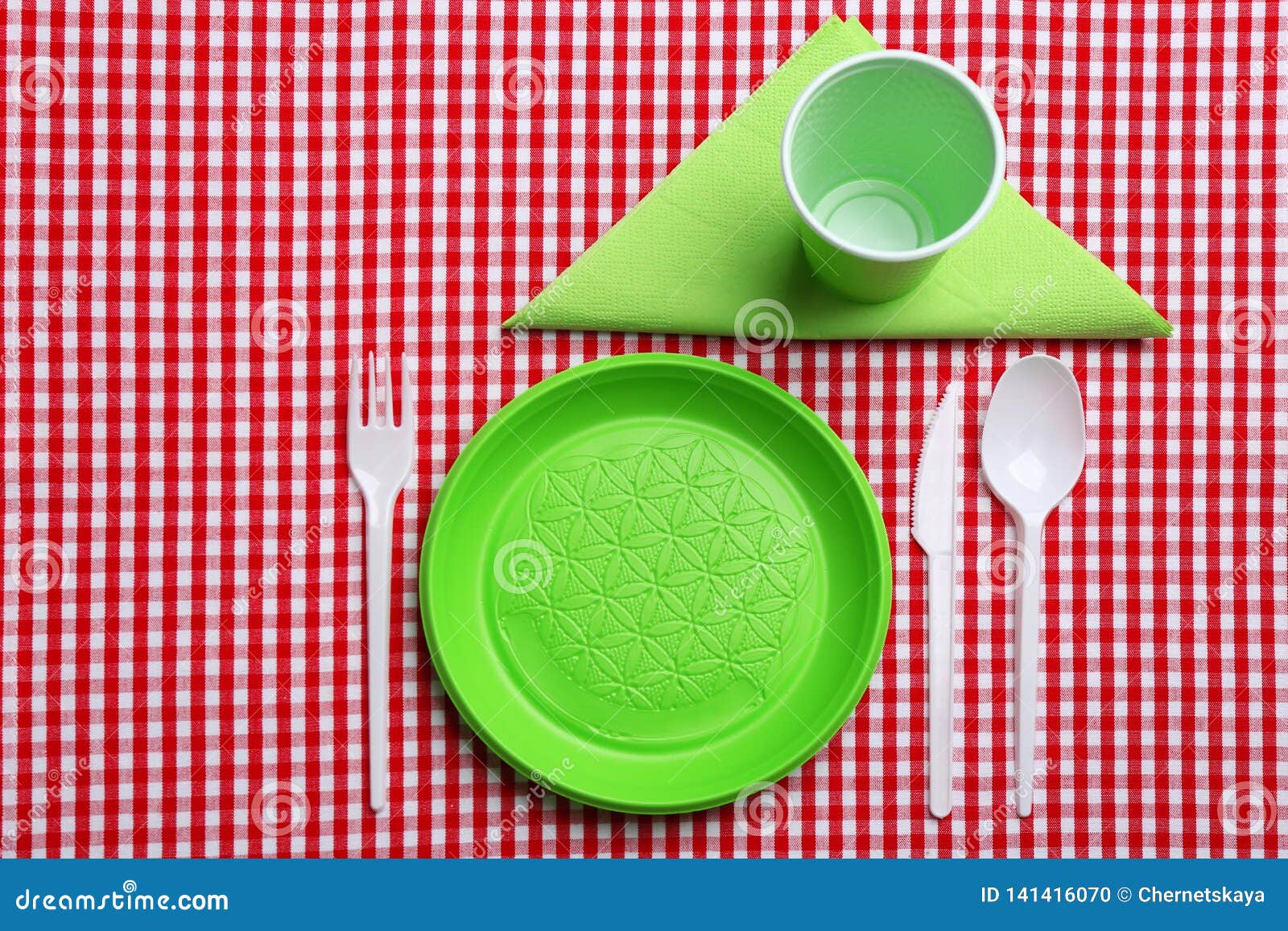 Table Setting with Plastic Dishware on Plaid Fabric Stock Photo Image