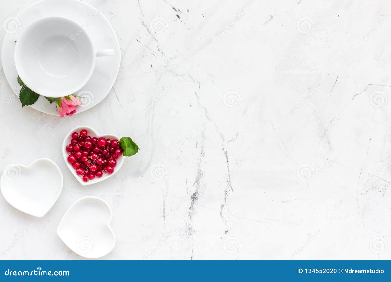 table setting with plates, wineberry and flower on stone kitchen background top view copy space