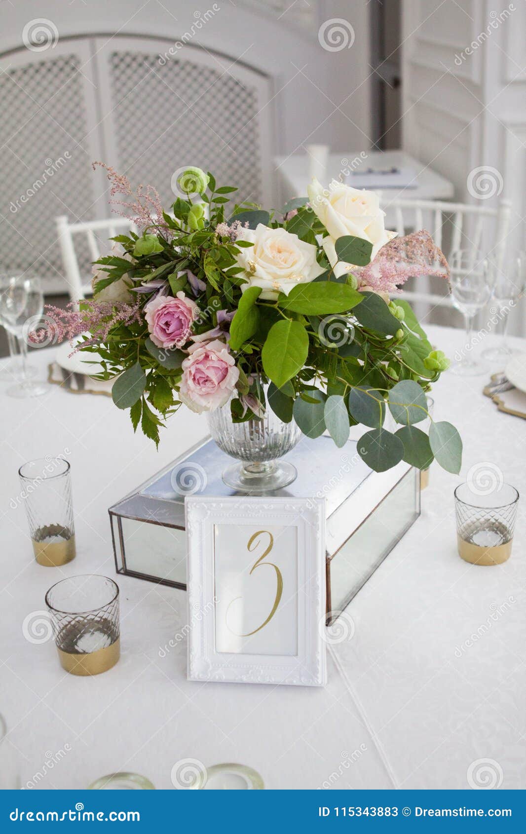 Table Setting with a White Tablecloth, Beautiful Flowers in Vases
