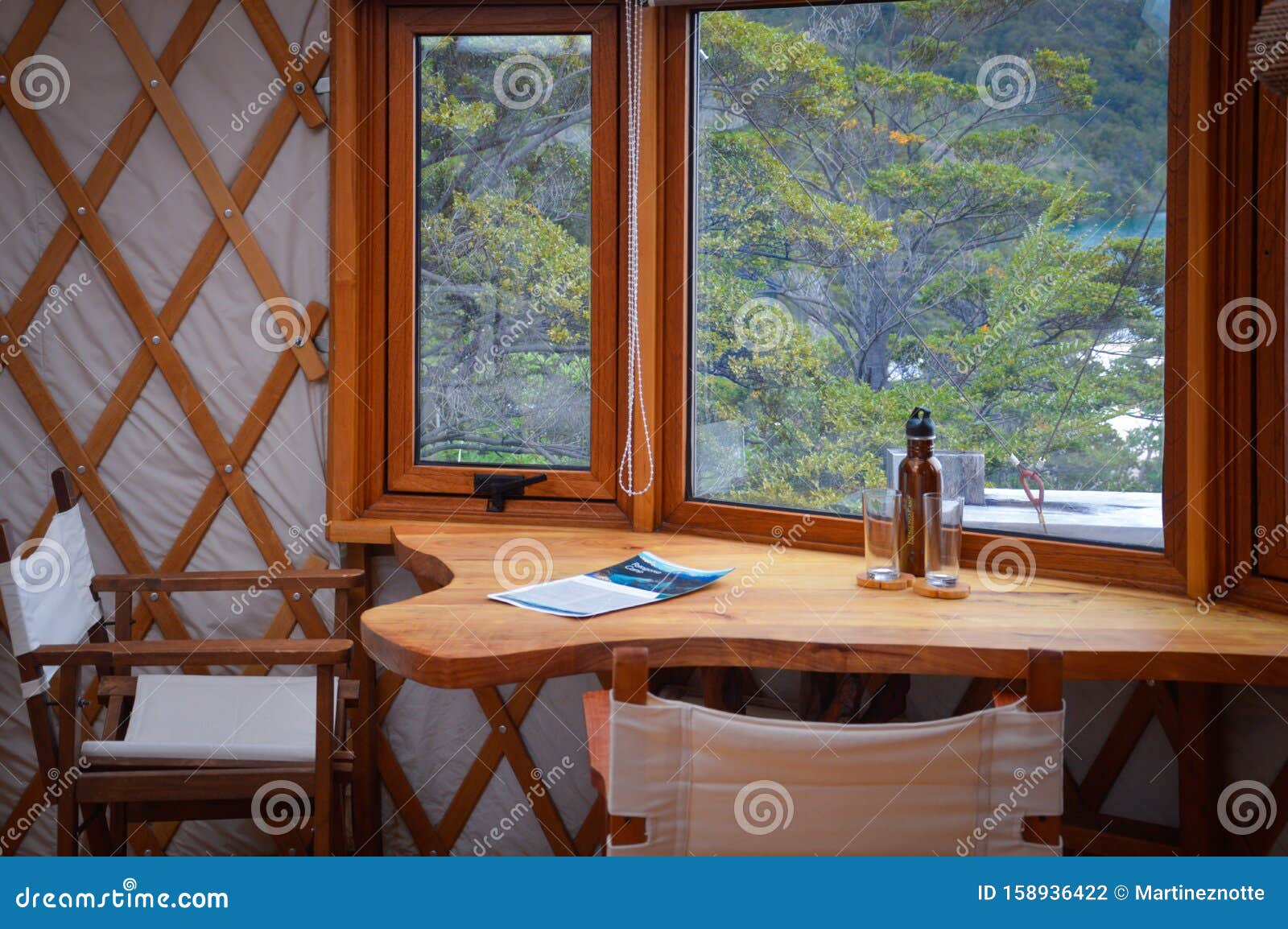 table between the window of the luxury yurt in the forest