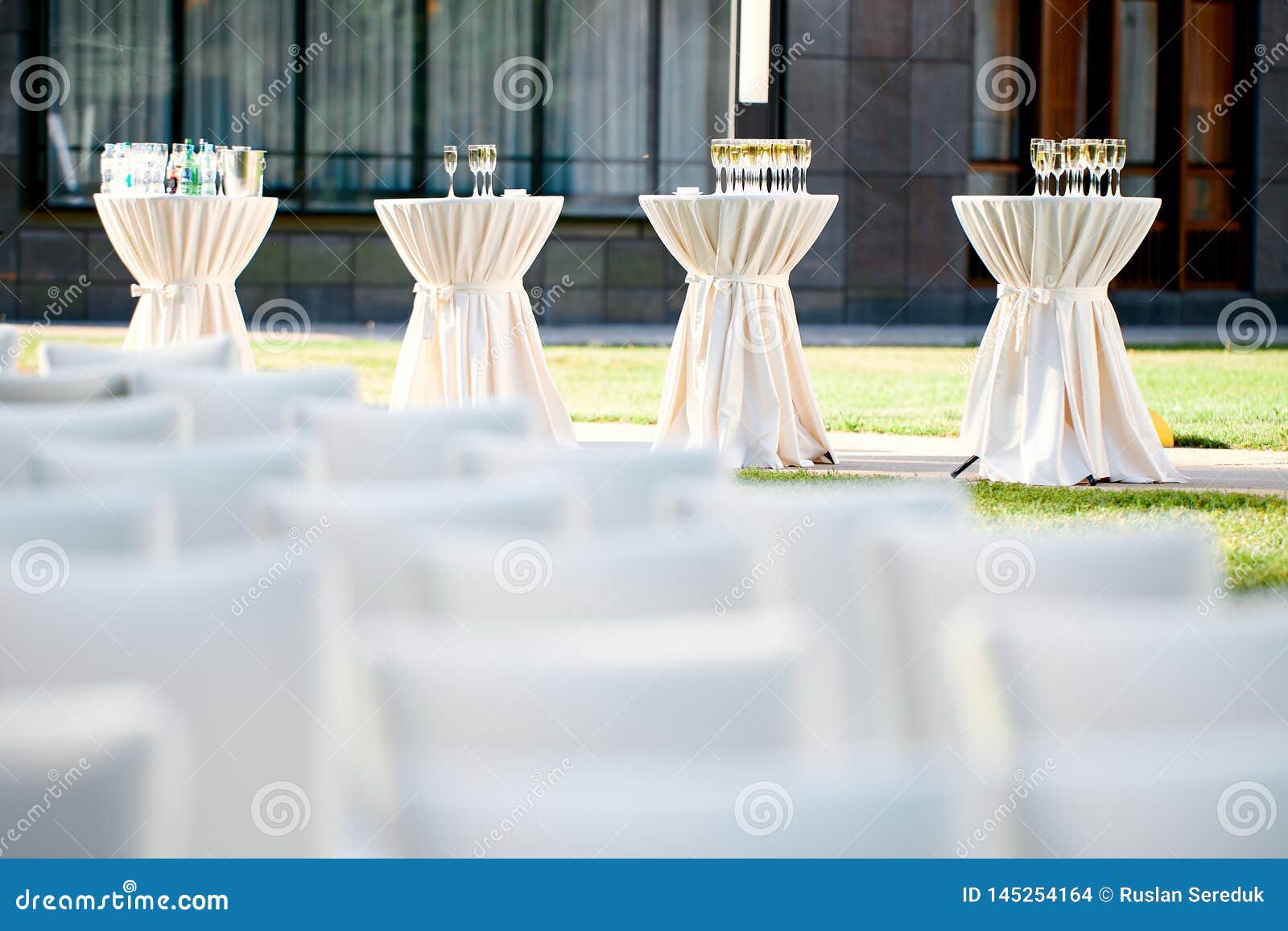 Tables with Drinks and Champagne Glasses in the Open Air Stock Photo