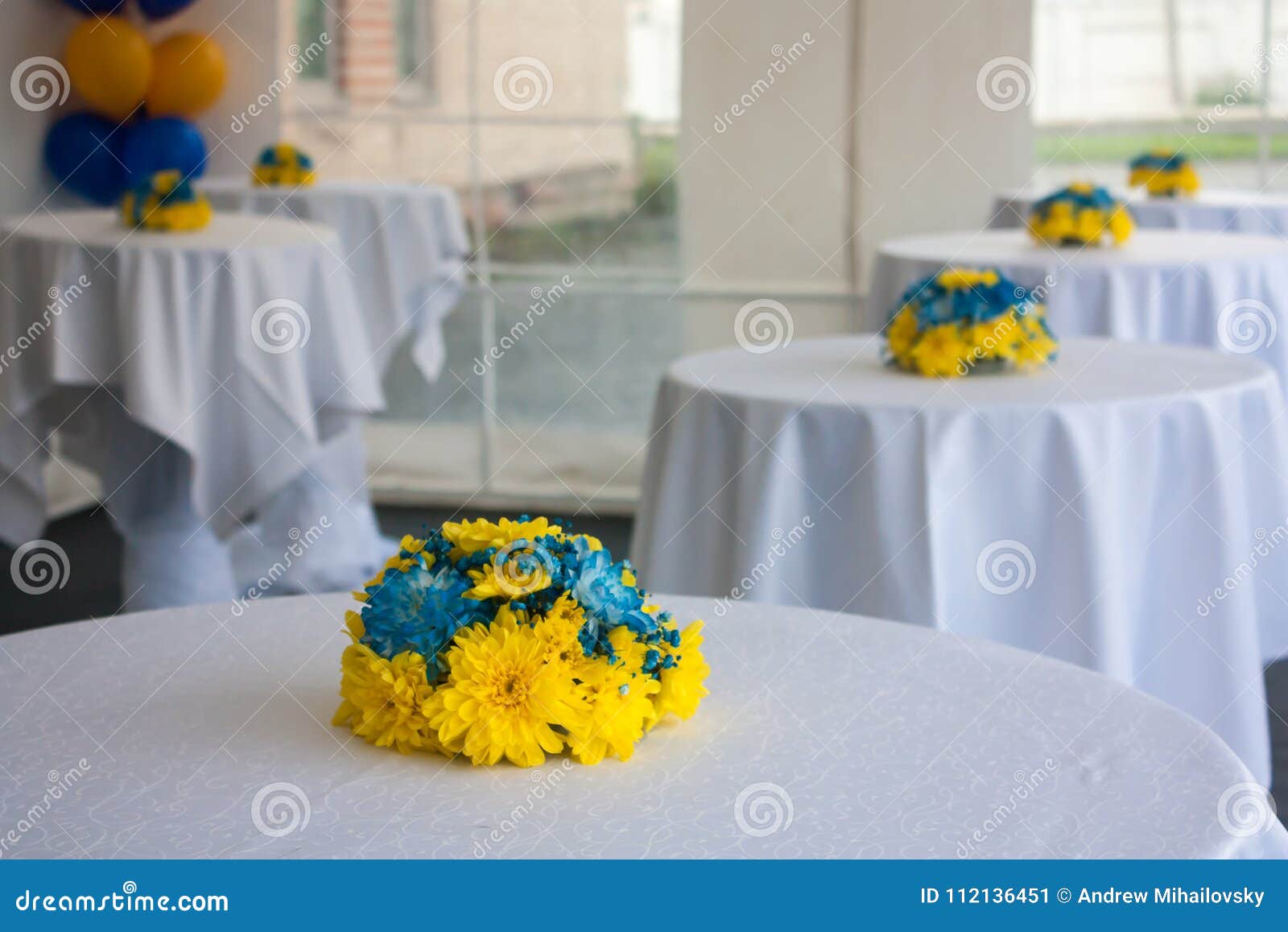 tables with white tablecloths decorated with flowers