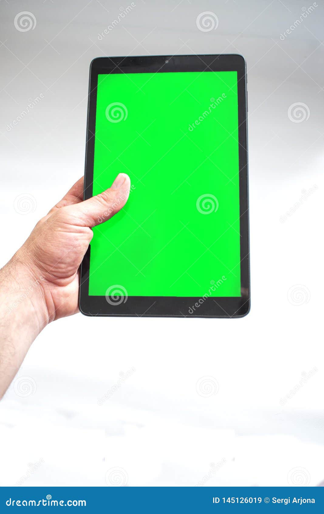 Tablet with Green Screen Fastened with One Hand on White Background