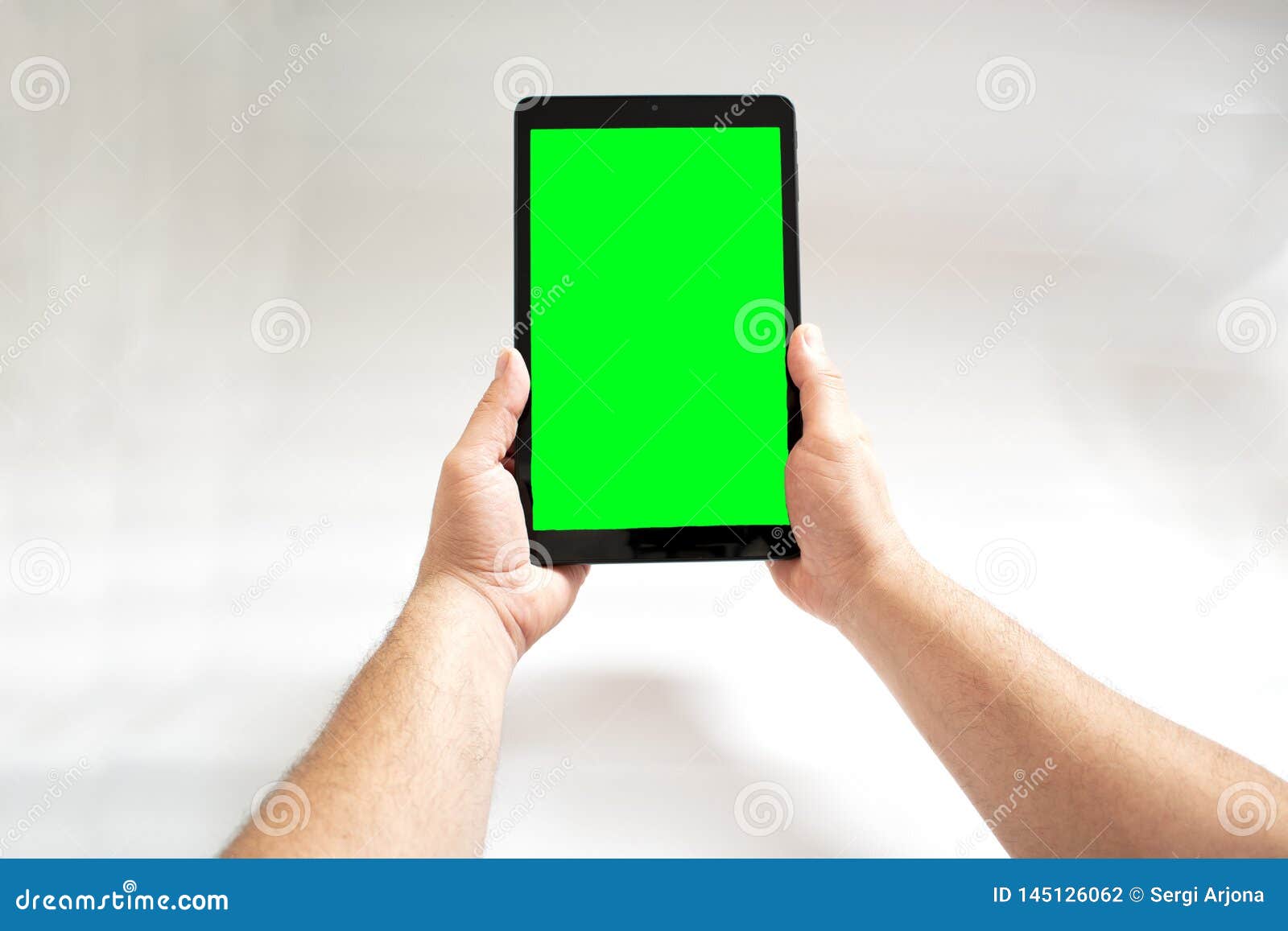Tablet with Green Screen Fastened with Two Hands on White Background