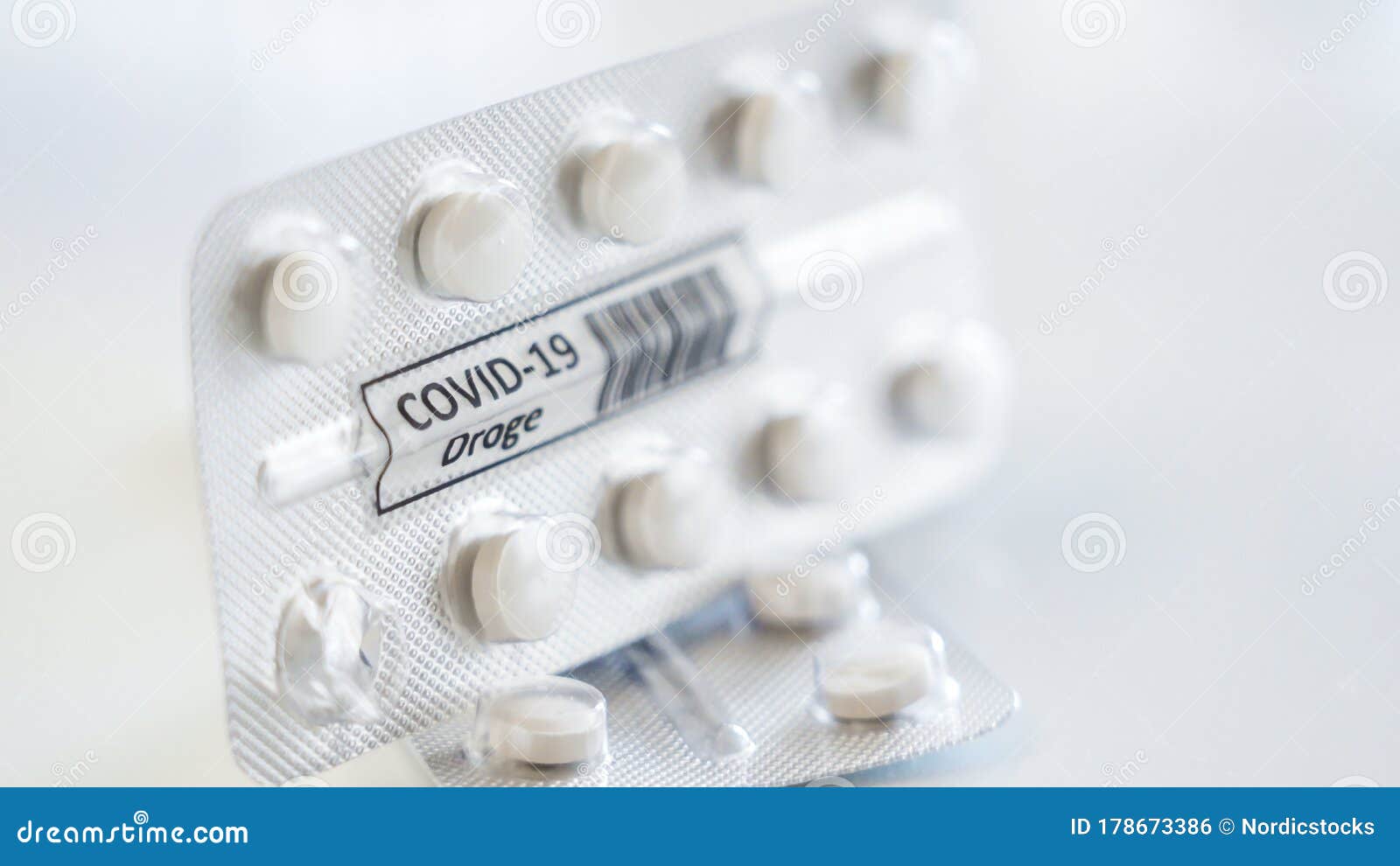 27917_the_tablet_medicine_with_the_drug_covid-19_droge_written_in_german_signage.jpg
