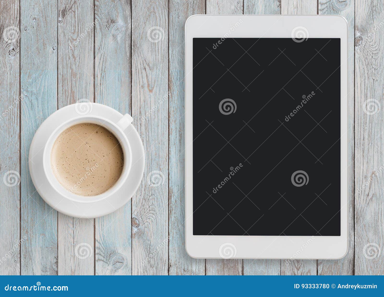 tablet pc looking like ipad on table with coffee cup