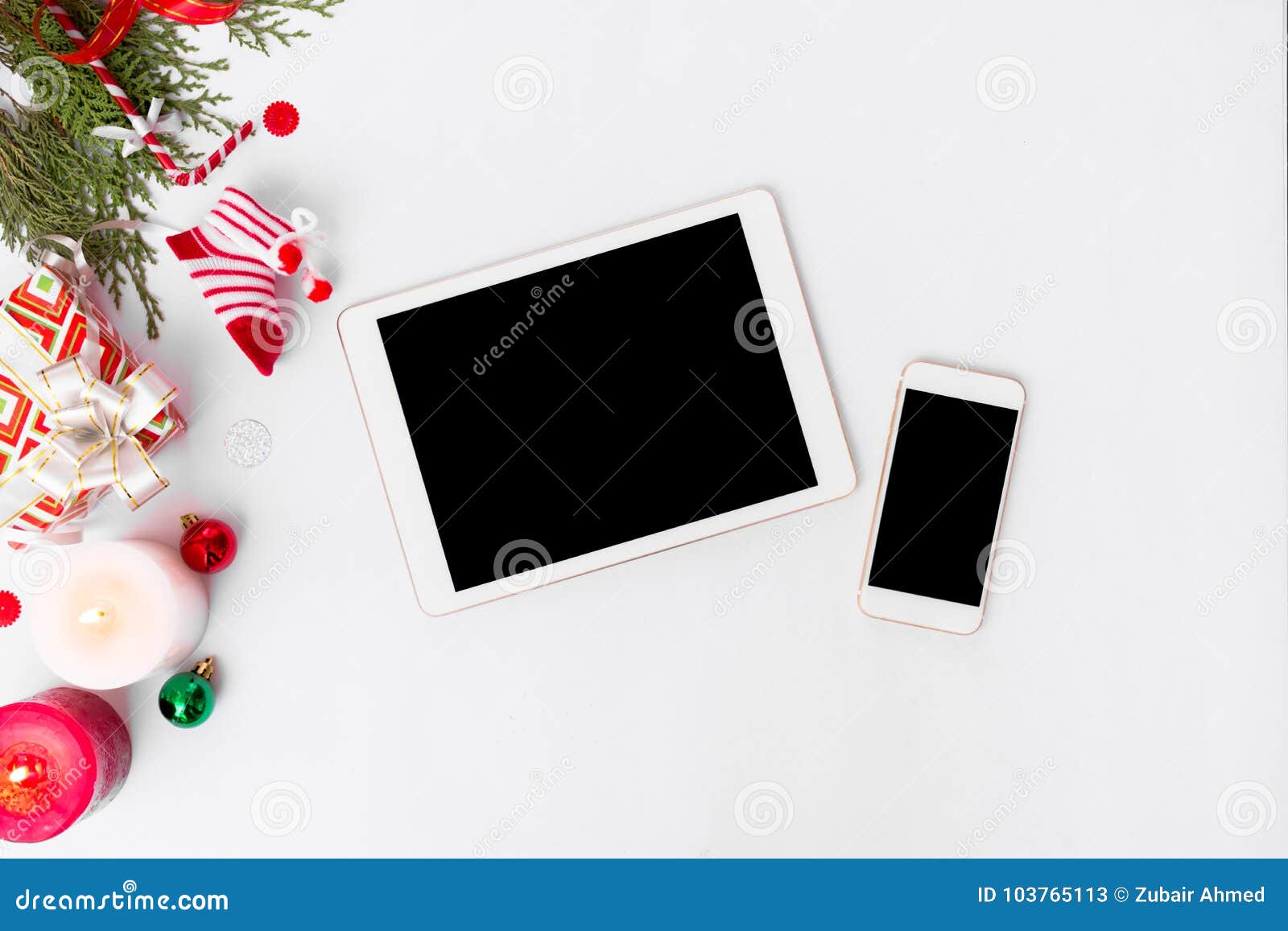 Tablet smartphone christmas position fir branches cones and christmas decorations on white background