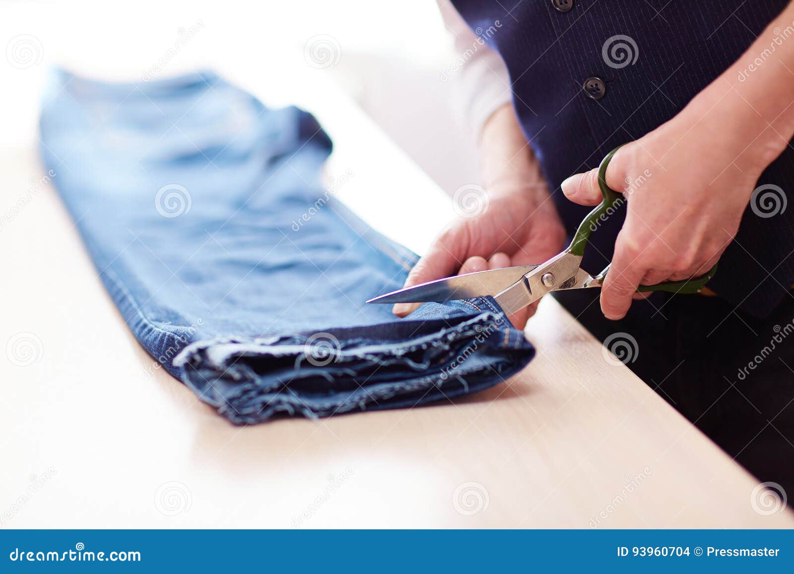 Tailor Cutting Old Jeans stock photo. Image of making 93960704