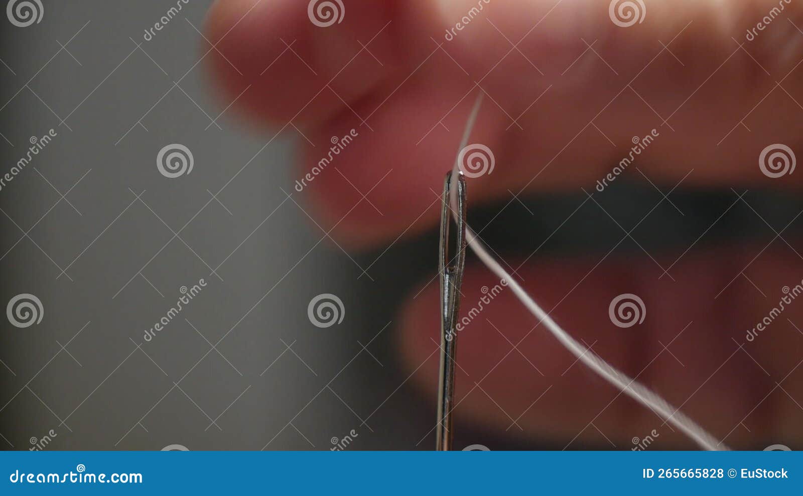 Tailor Hand Inserting Sewing Thread in Needle Hole. Man Preparing