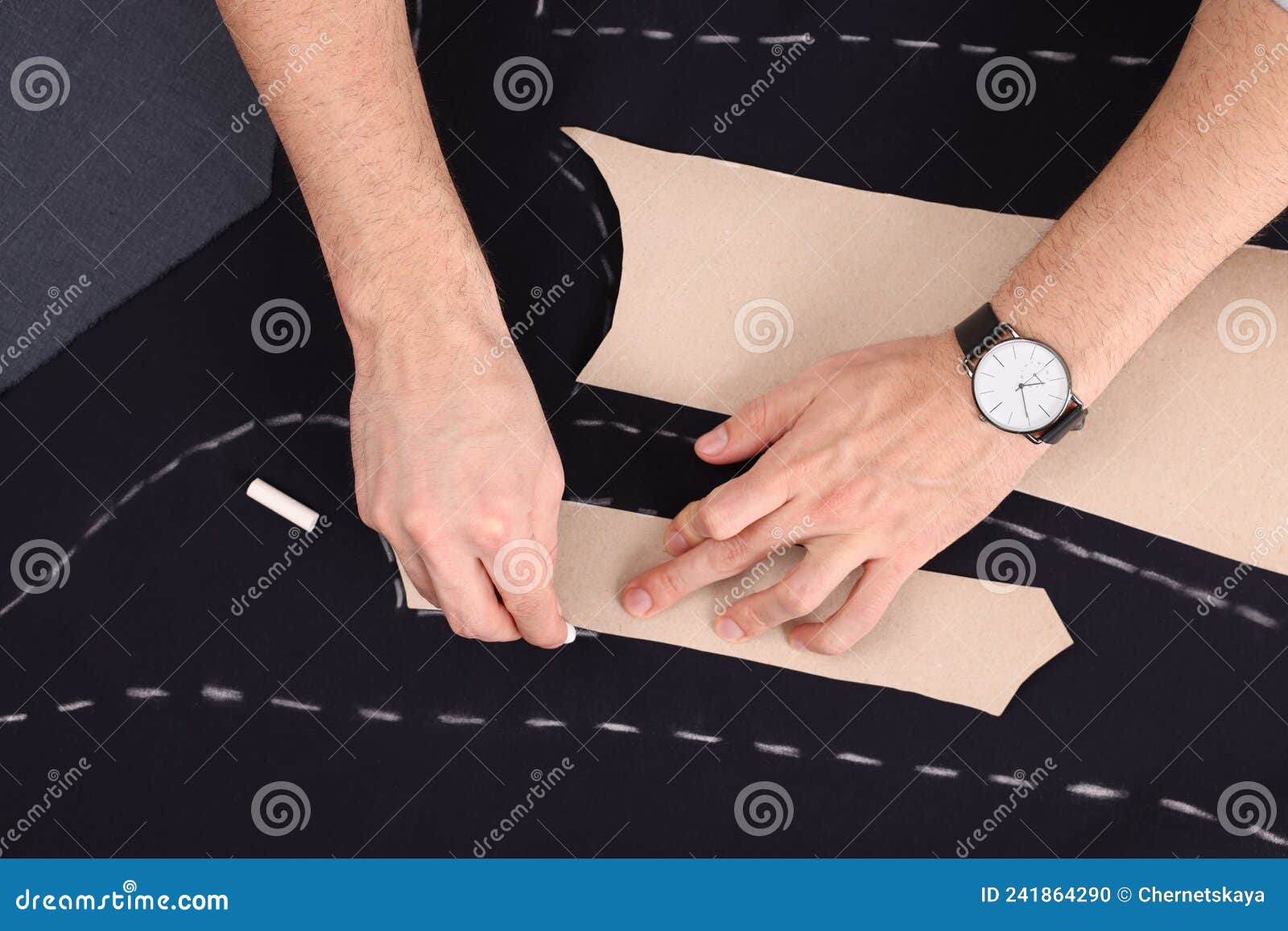 Tailor Marking Sewing Pattern on Fabric with Chalk at Table, Top View