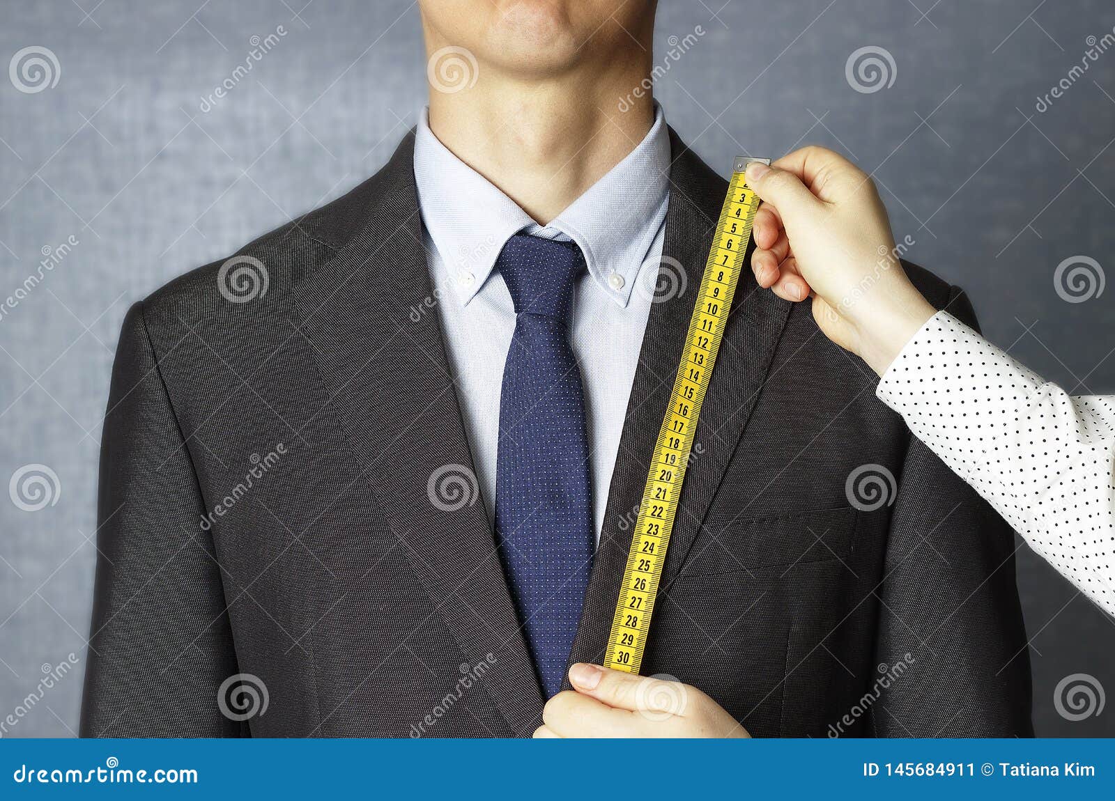 The Tailor Measures the Suit with a Measuring Tape Closeup Stock Image