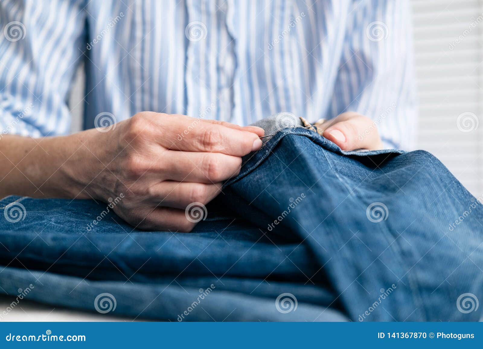 Tailor Sew the Hem of Jeans in Stock Photo Image of