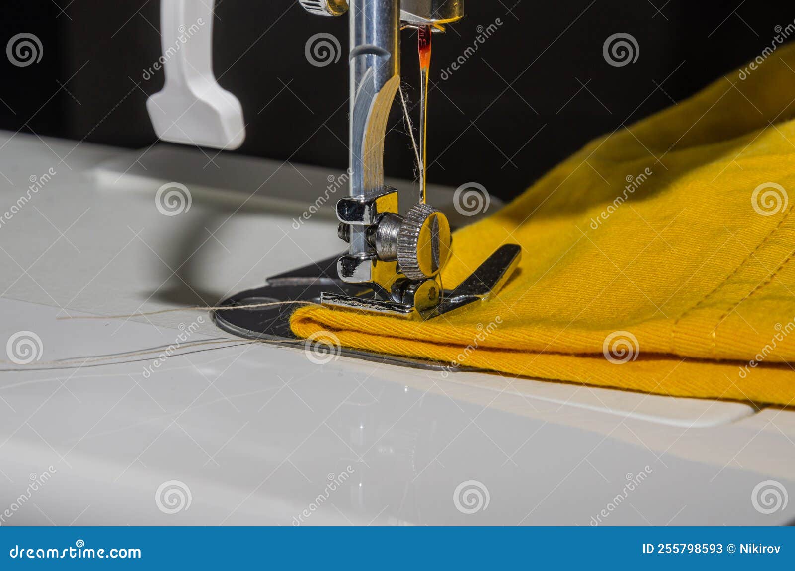 Tailor Sews Fabric for Clothing on a Sewing Machine in a Tailor Shop