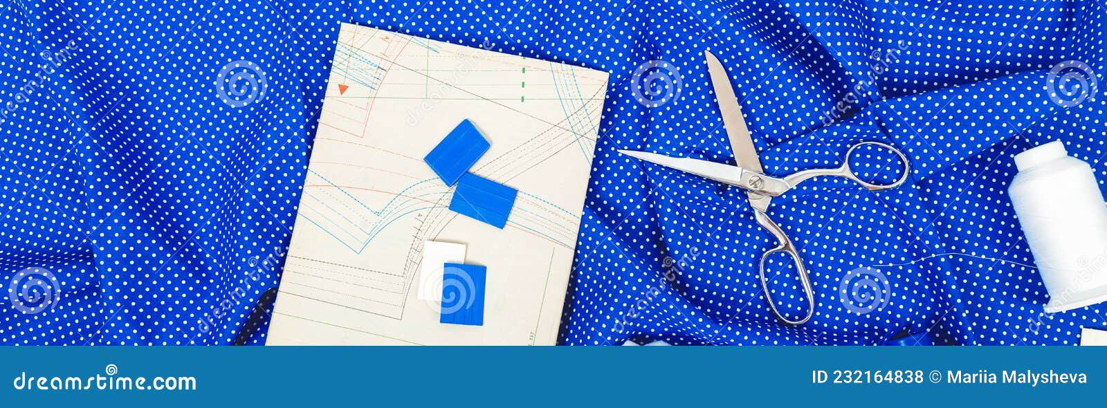Tailor Work Place with Thread, Scissors, Blue Fabric, Pattern, Tools