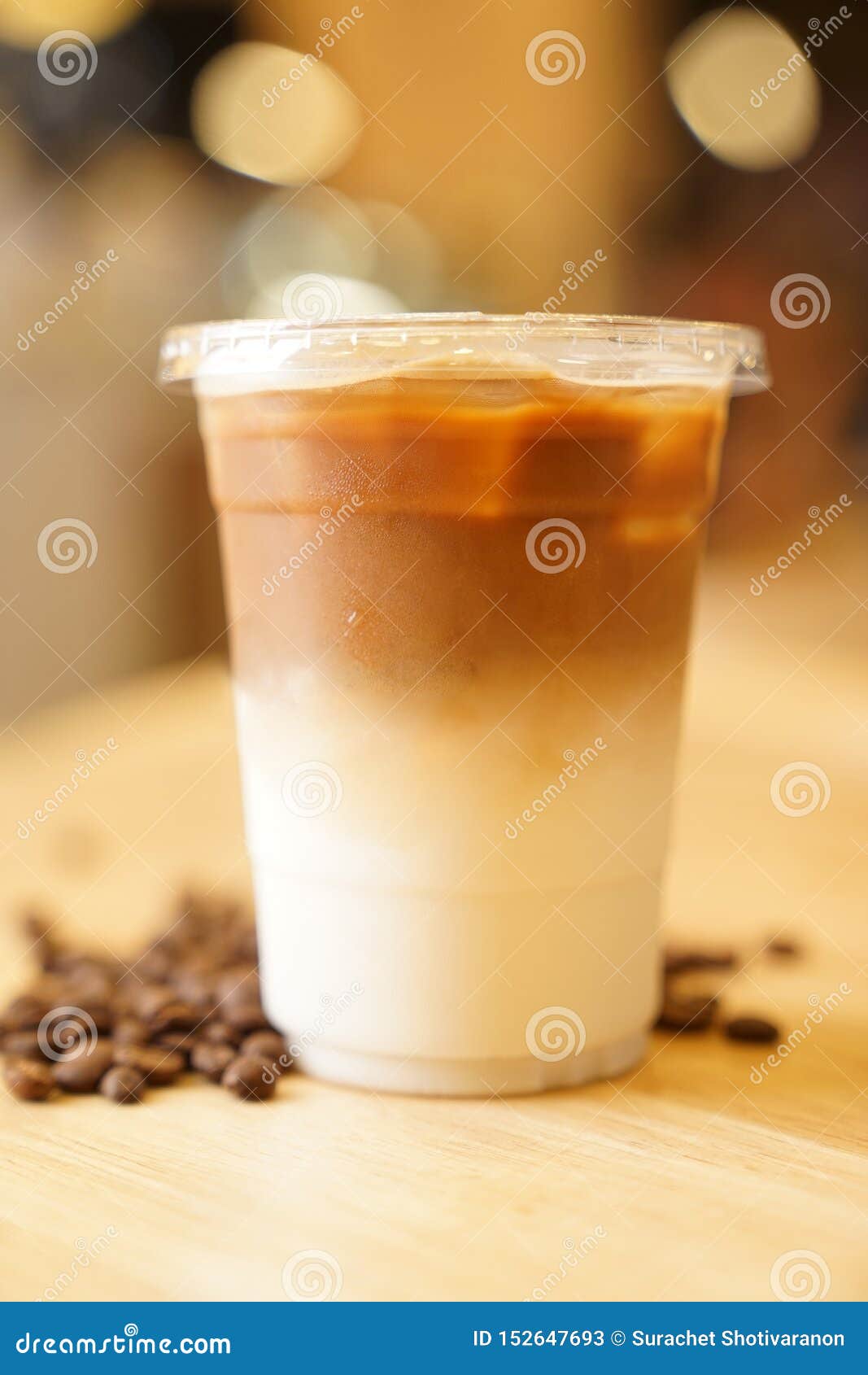 Take Away Latte with Coffee Bean Around on the Wood Table Stock Image