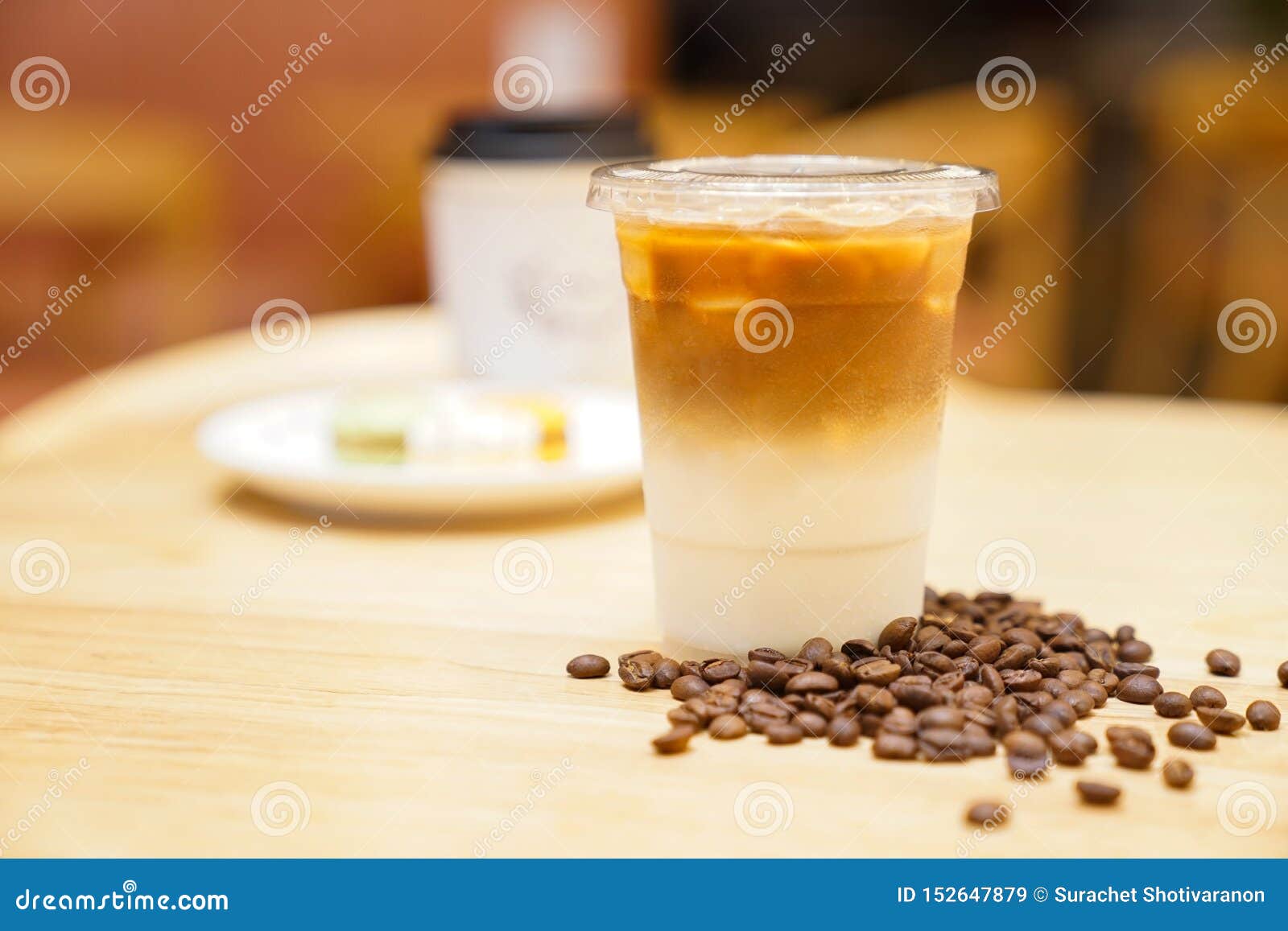 Take Away Latte with Coffee Bean Around on the Wood Table Stock Image