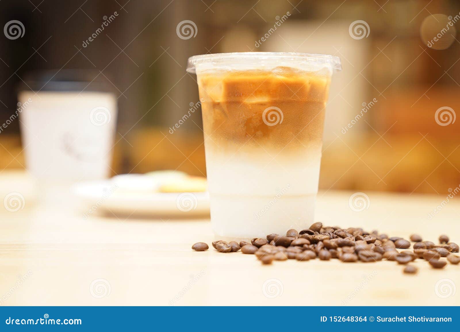 Take Away Latte with Coffee Bean Around on the Wood Table Stock Photo