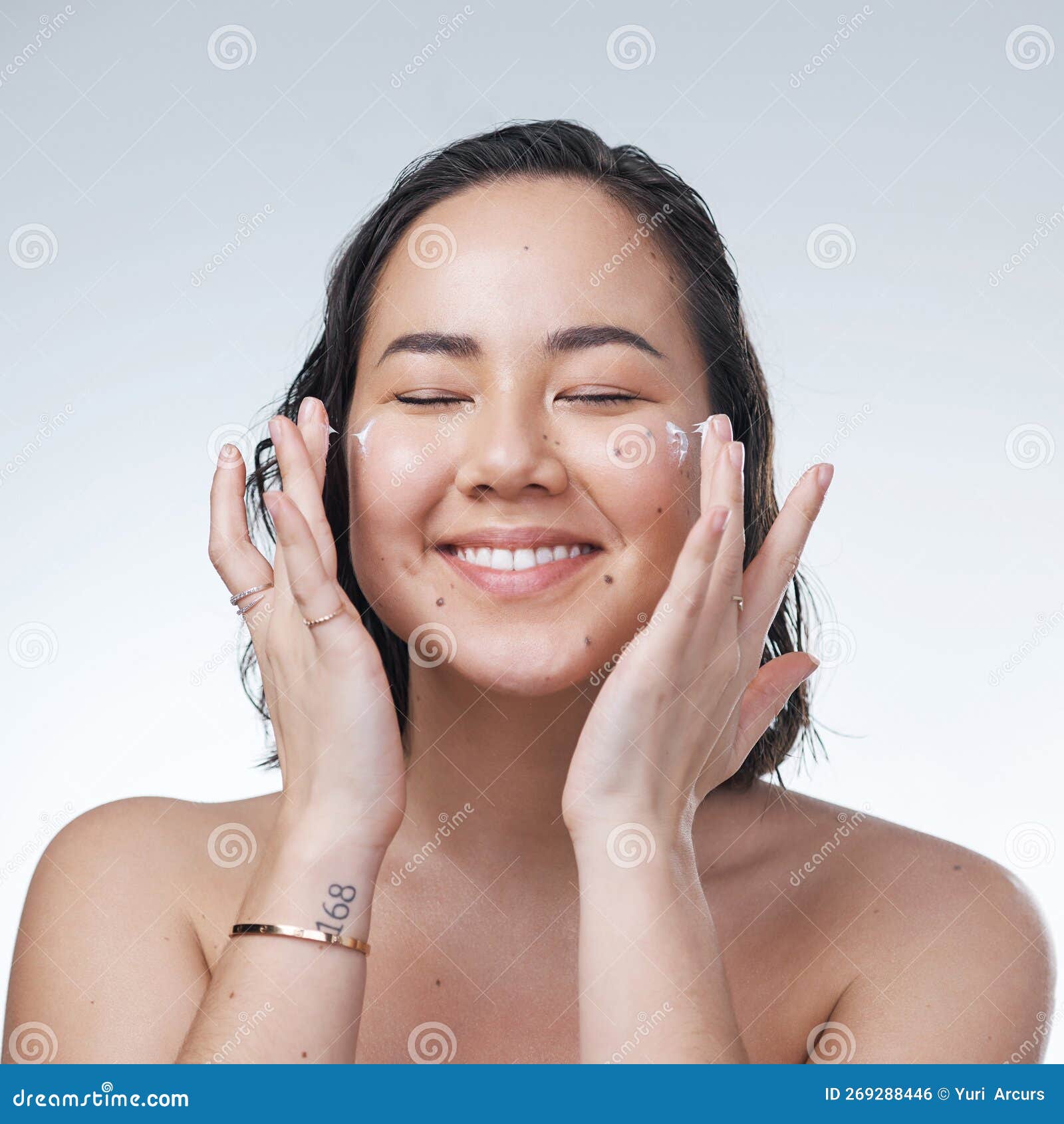Take Good Care of Your Skin. a Beautiful Young Woman Applying