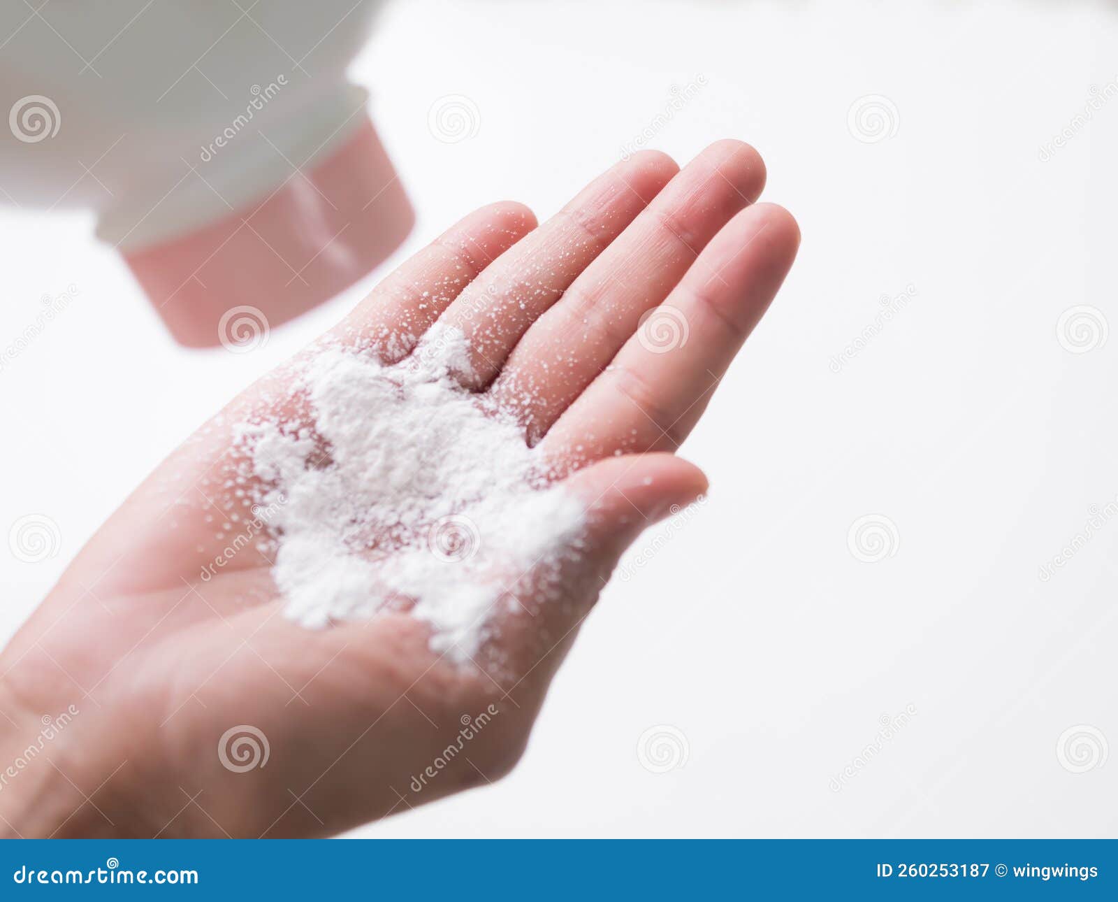 talcum to hand on white background