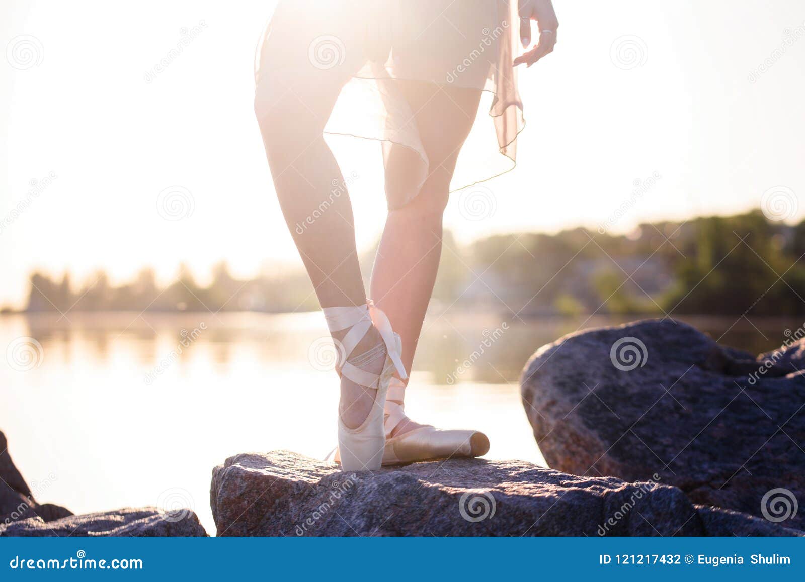 Talented Ballerina with Pointe Shoes on the Beach at Sunset Stock Photo