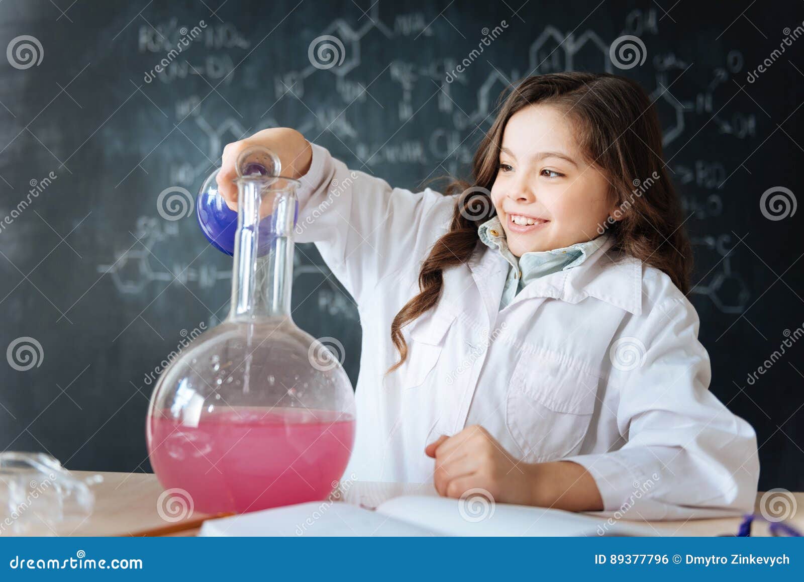 talented little girl taking part in science experiment in the laboratory