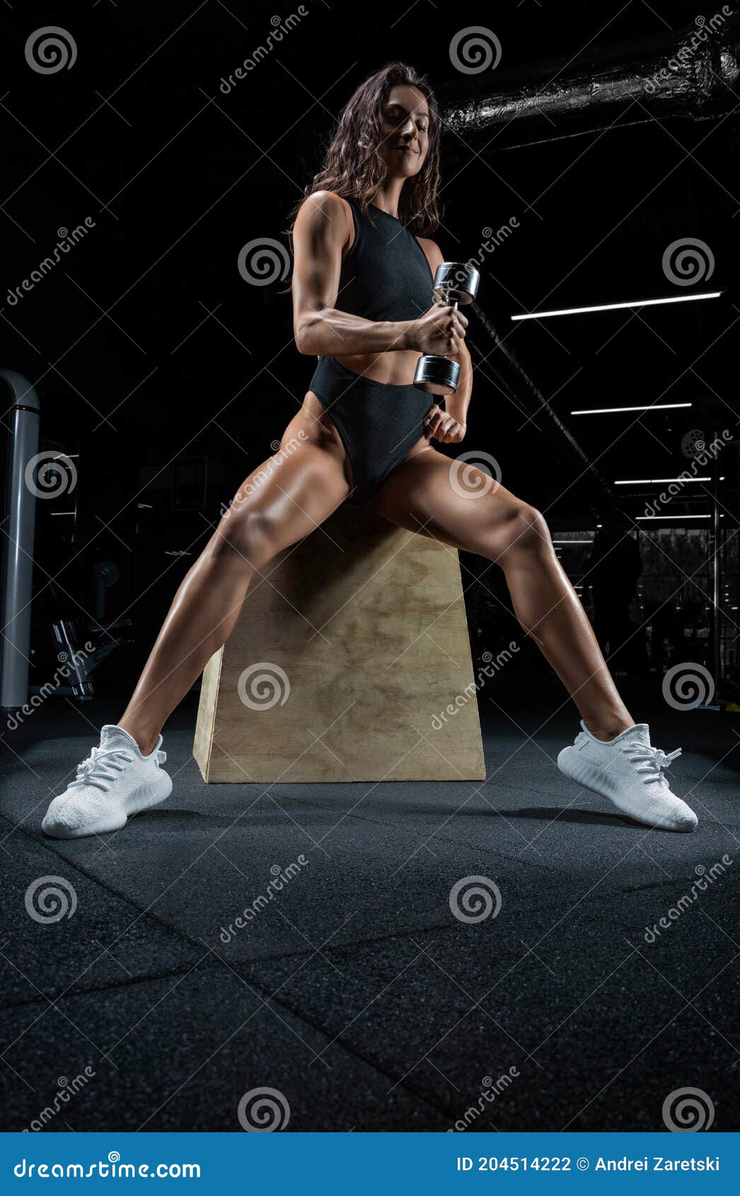 Tall Athletic Woman Posing in the Gym on a Bench with Dumbbells. Biceps  Pumping Stock Photo - Image of body, bodybuilder: 204514222