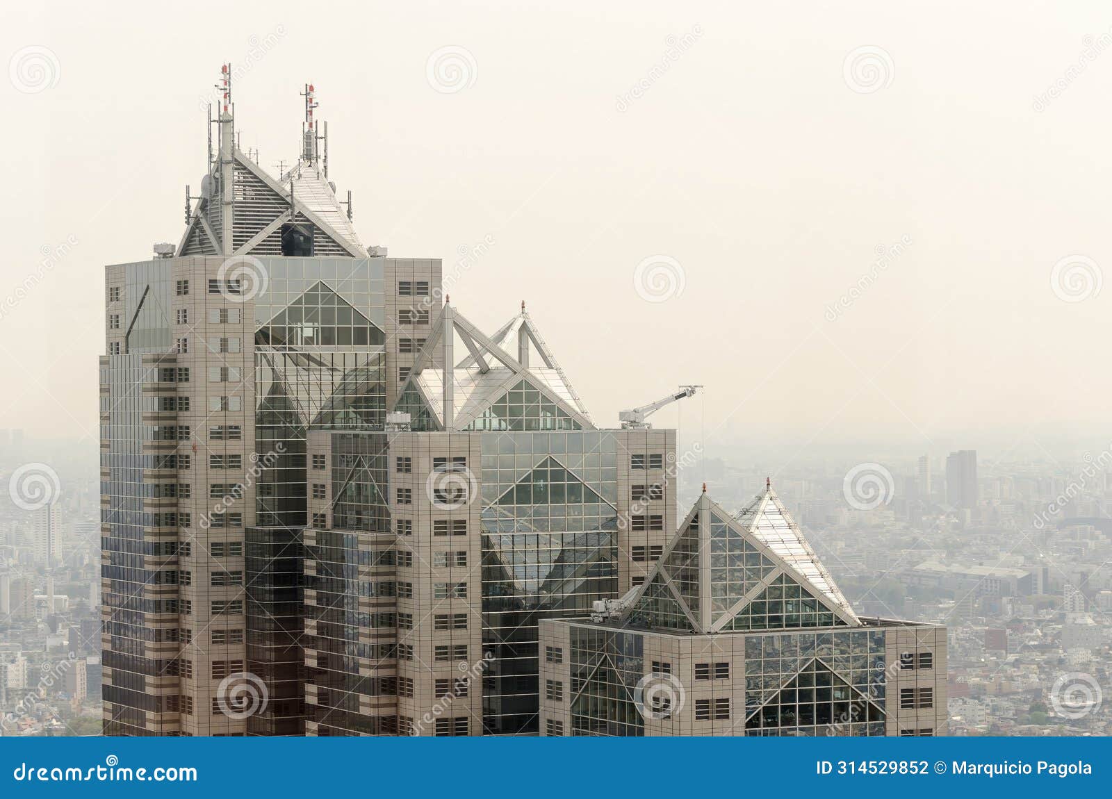 a tall building with a lot of windows and a triangular roof