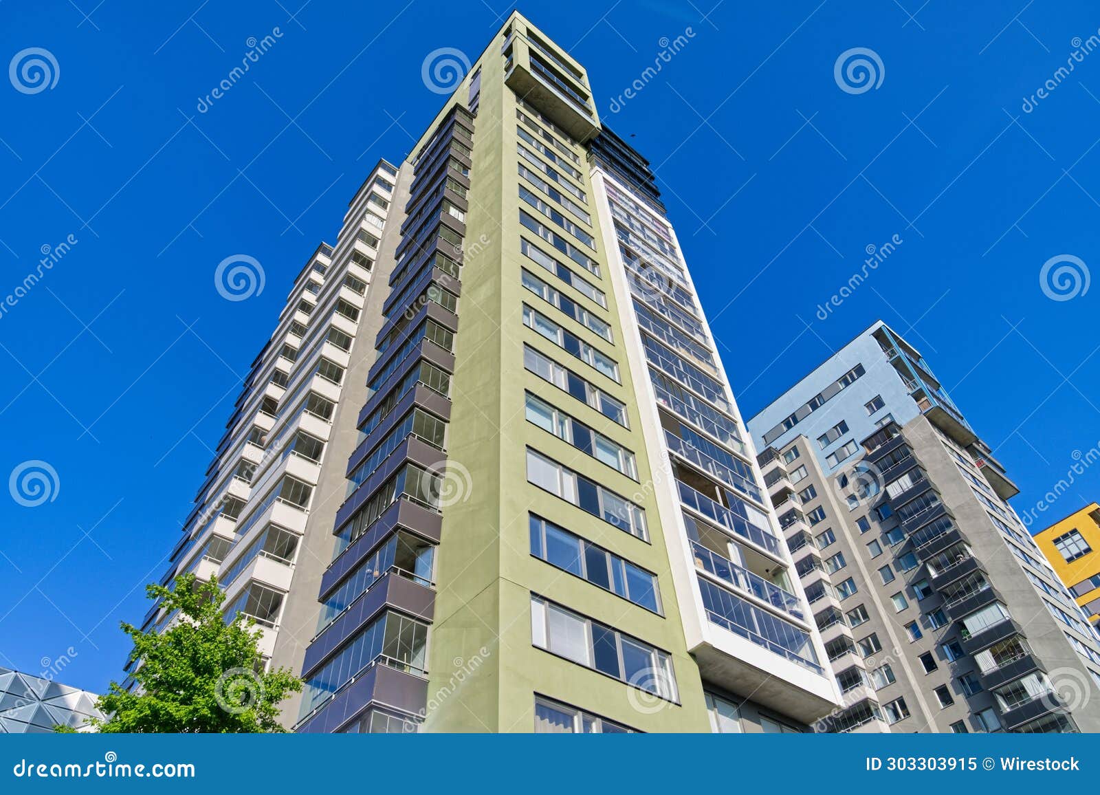 A Tall Building with Lots of Windows and Green Trim Around the Front Stock Image Image of