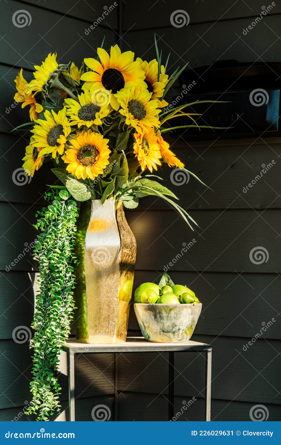 Tall Vase with Sunflower Blossoms on Table in Front Door Entry Stock