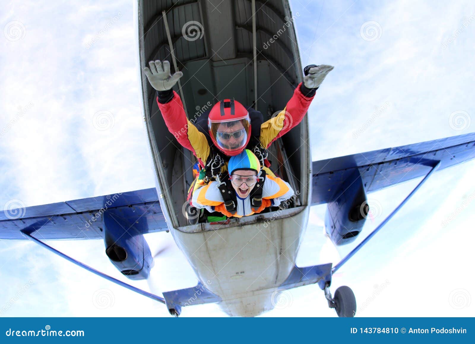 tandem skydiving. active woman are jumping out of a plane.